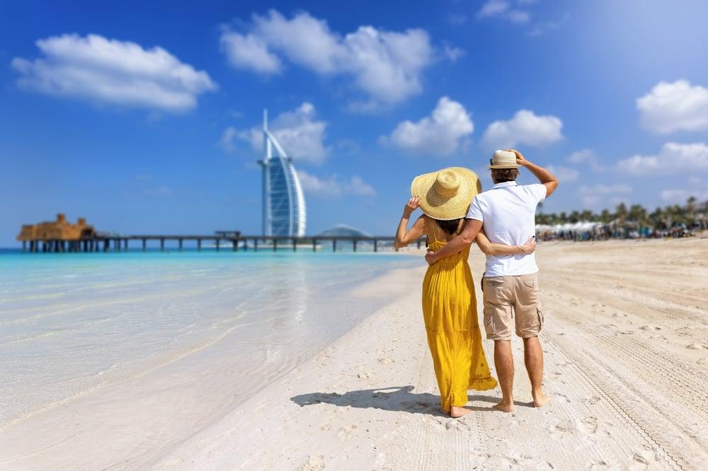 Couple stands hugging on a beautiful beach in Dubai