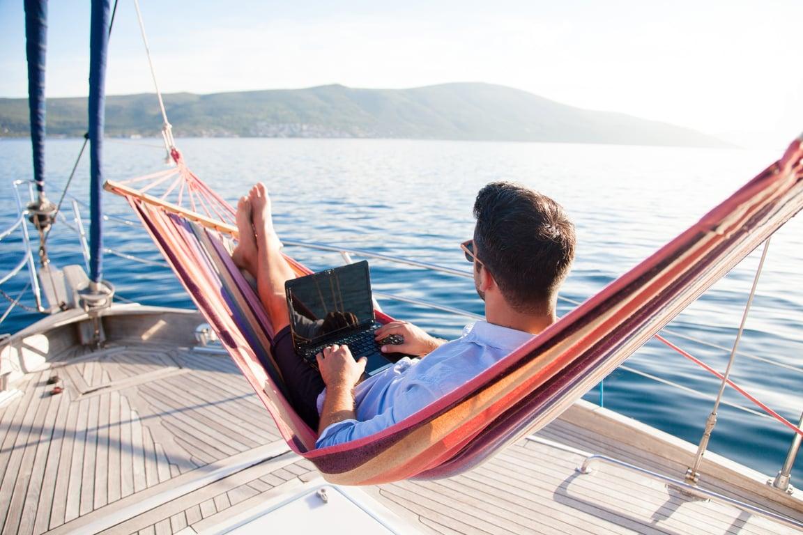 Man lying on a hammock on a yacht