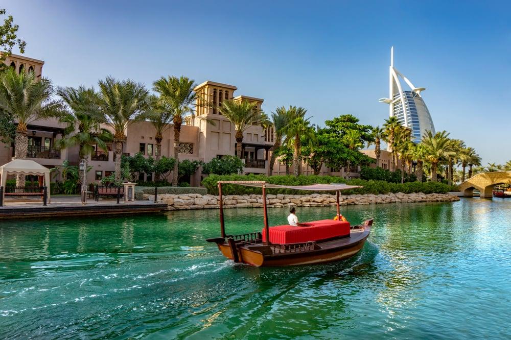 An abra boat ride in Souk Medinat Jumeirah with the Burj al Arab in the background